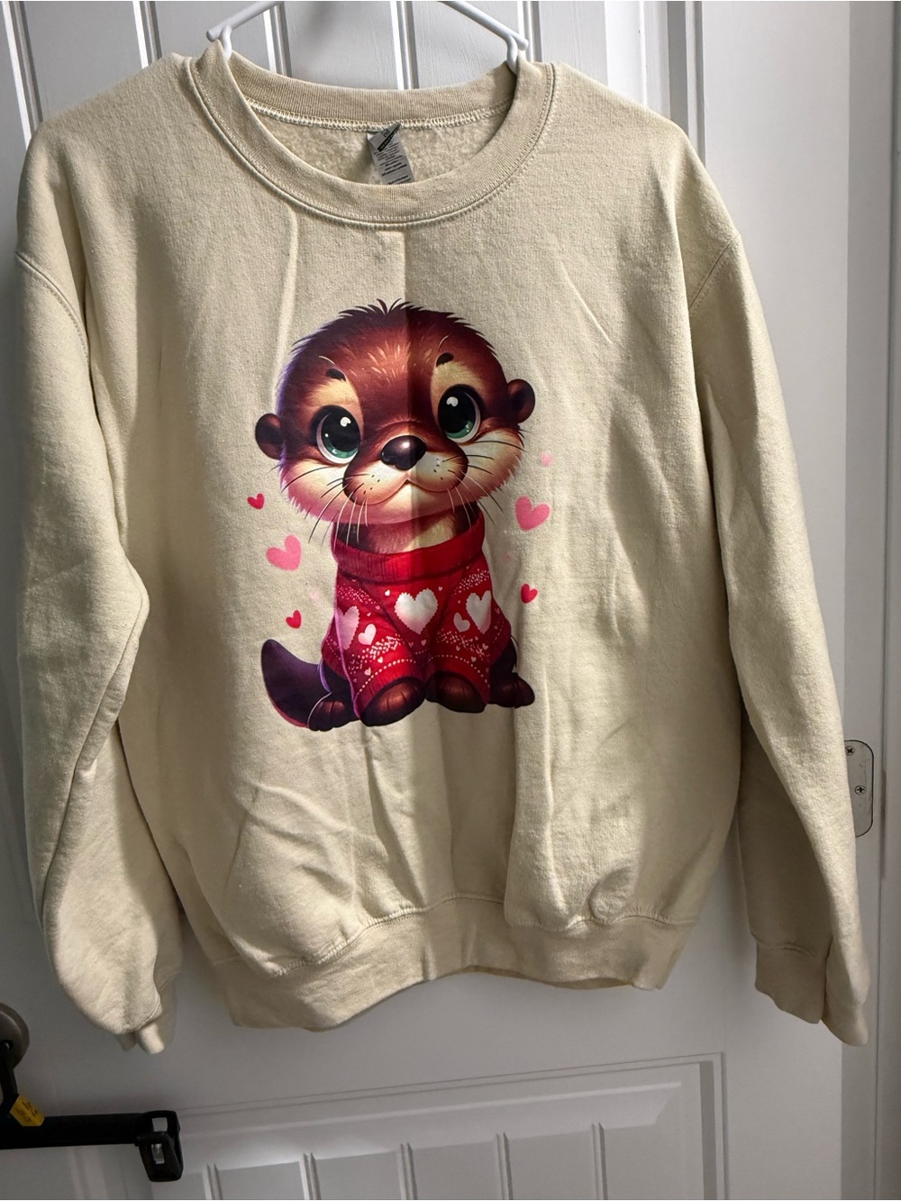 Gildan Cream Sweatshirt with Otter Wearing Red Sweater and Pink Hearts